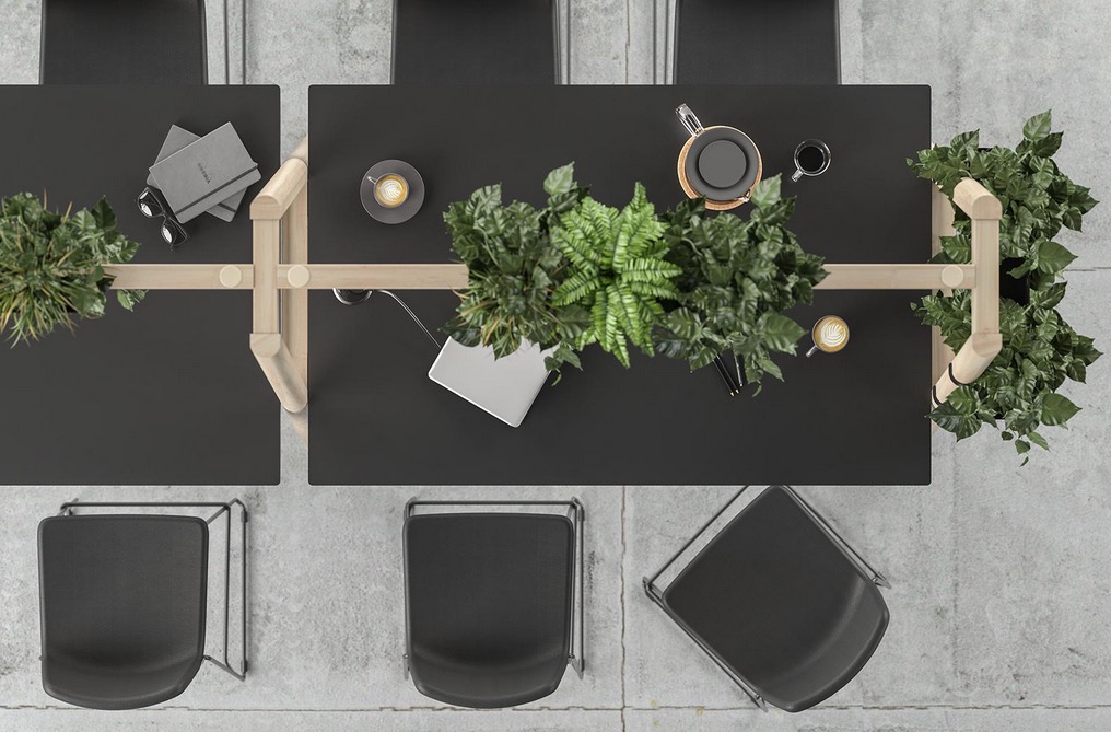 A photo of office team tables with wooden planted frame from Narbutas