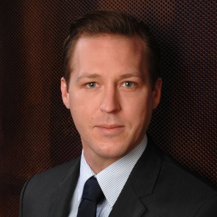 Photograph of Bastian Walke dressed in a business suit