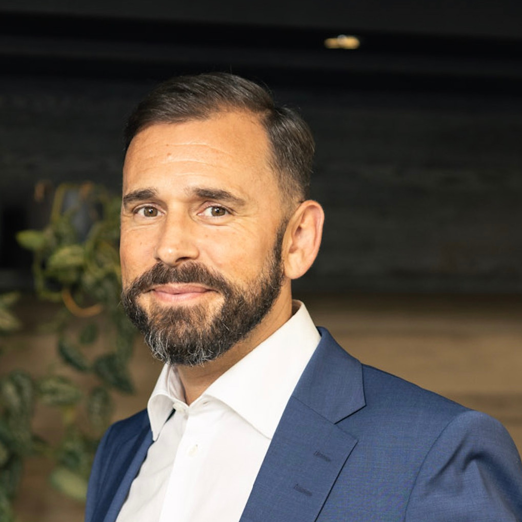 Photo of Robin Wycherley facing the camera, wearing a suit